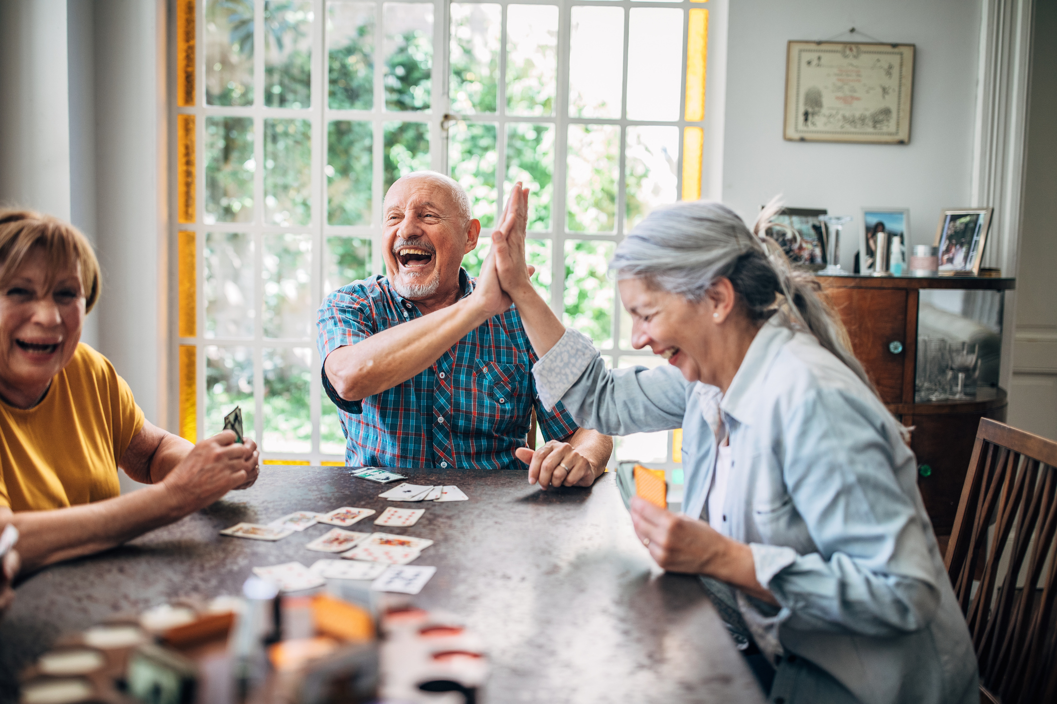Senior people playing cards in nursing home Group of people, senior people playing cards in nursing home.